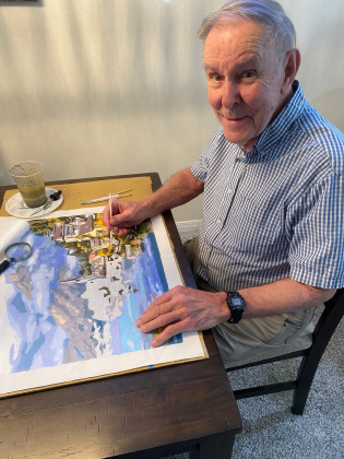 With a look of joy, George Egbert paints his latest canvas.  (PHOTOS BY ELLEN GREENEY)