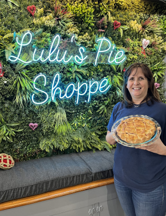 Lisa Franke stands with a cherry pie.