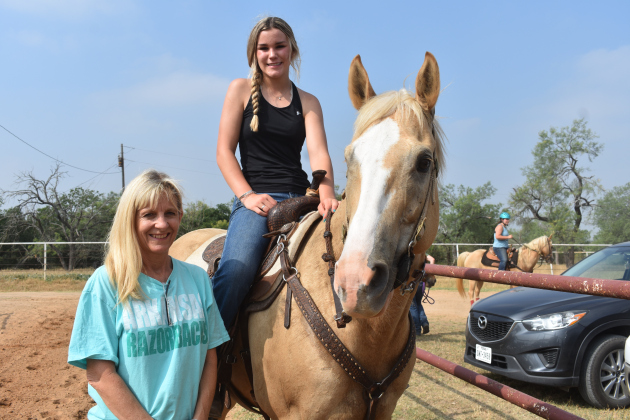 Windsong Farm co-owner Kelly Clayman, left, stands with new Texas State Champion Jaycee Ferguson. She is riding her horse, Izzy. Photo by Katherine Anthony