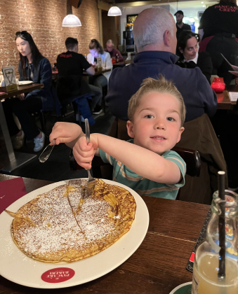 Grandson Simon eats a Dutch pancake in Amsterdam. 