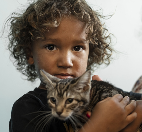 2-year-old Landry Miles cuddles a kitten during the Georgetown Animal Shelter's kitten adoption event.