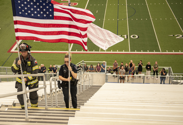 Georgetown Fire Department Captain Aubrey Reeves, left, and Georgetown Police Department officer Ashley Wall, right, post the colors at the beginning of the Memorial Stair Climb.  Officer Wall is holding the Flag of Heroes, with the names of first responders who died during the 2001 attacks. 