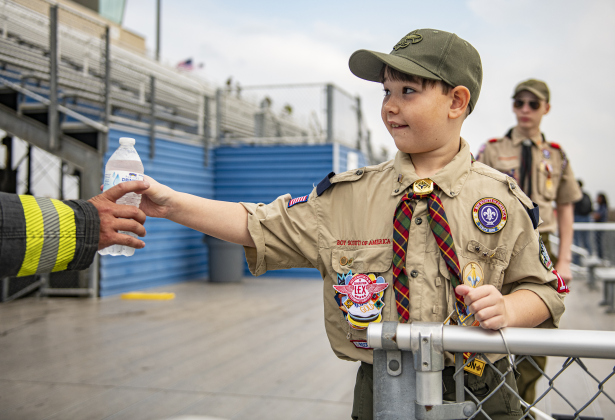 9-year-old Caden Taylor, with Cub Scout Pack 151, joined other scouts, including his brother Cole, 12, (back right), with Boy Scout Troop 1096,  to hand out hydration drinks.