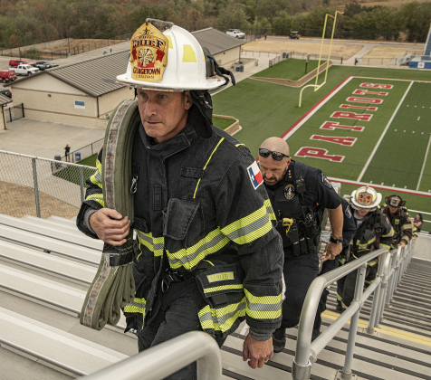 Georgetown Fire Chief John Sullivan, front, and Police Chief Cory Tchida (behind Sullivan) participate in  the Memorial Stair Climb.