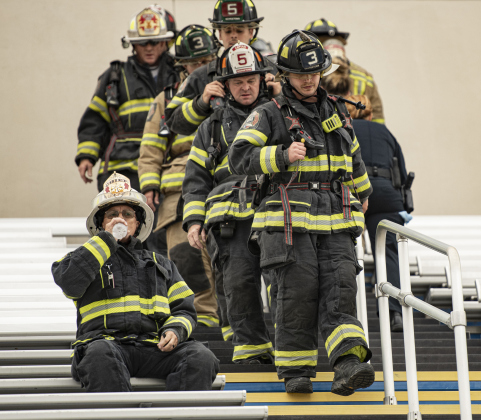 Georgetown Fire Department Battalion Chief Scott Gibson, left, takes a brief rest before continuing his climb during.