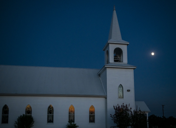 A Waxing Gibbous moon, at 92.1% visibility, shines  over St. Peter's Church of Coupland on Tuesday, September 26, 2023.