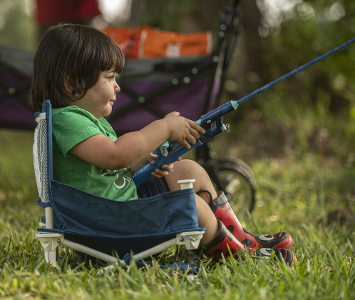 2-year-old Emma Richardson concentrates on her angling skills.