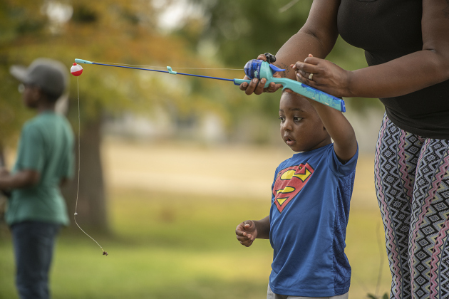 3-year-old Tyree Flowers gets guidance from his mom Ashley Flowers.