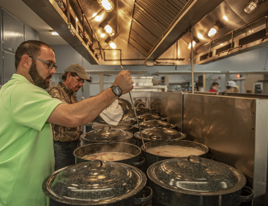 Charlie Brown, left, and Scott Janke, right, check on status of many pots of boiling potatoes in the recreation hall kitchen.