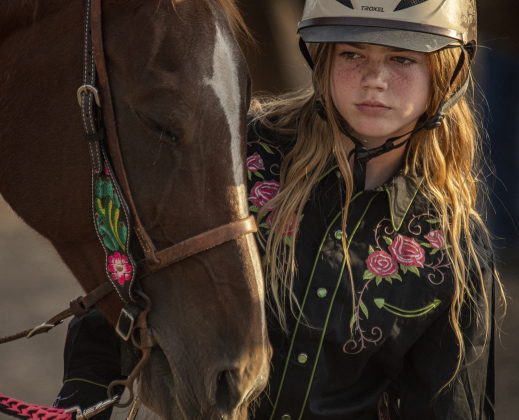 Clara Gulbranson relaxes with her horse named Rose before the Polebending competition.