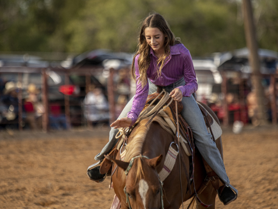 Annie Picken praises her horse after they competed in Senior Breakaway Roping.
