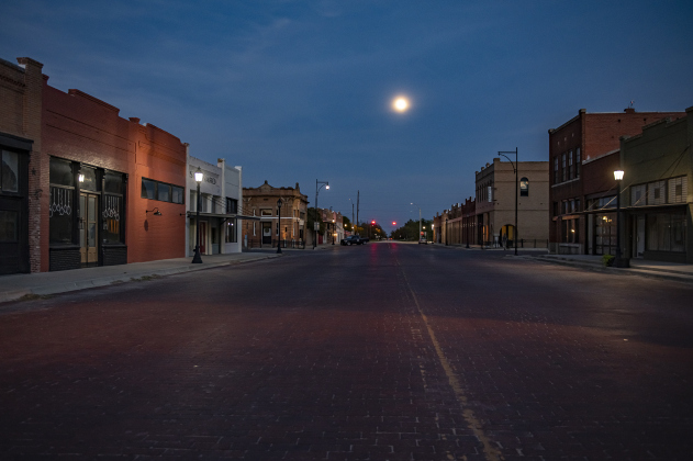 A Waxing Gibbous moon, at 97.1% visibility, shines over Clark Street in downtown Bartlett on Wednesday evening, September 27, 2023.  The left (north side) of this street is in Bell County, the right side (south side) is in Williamson County.