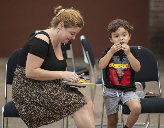 Jessica Kirby enjoys hamburgers and hot dogs with her son Issac Garcia, 5, during a National Night Out event held at Stonehaven Apartments. Kirby is the Assistant Manager at Stonehaven Apartments.