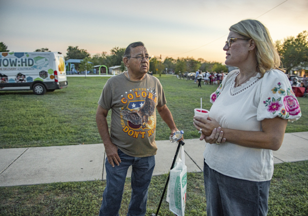 Lupe Carranco, left, visits with Georgetown City Council member Amanda Parr during a National Night Out event held at San Jose Park.  Parr hosted tonight's event here.