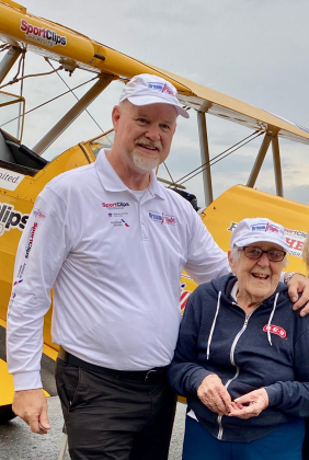 DreamFlights founder, president and pilot Darryl Fisher poses with Betty McCann after their flight.