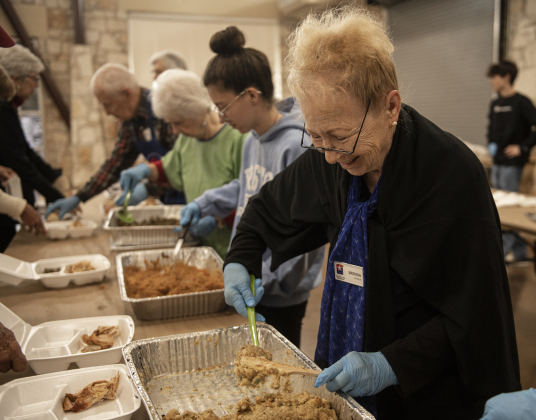 Brenda Scholin helps prepare to-go meals for delivery to area homes during the Community Thanksgiving, held at the Georgetown Community Center in San Gabriel Park on Thursday, November 23, 2023.