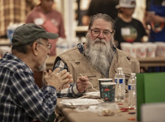 Diners  Gary Rodriguez, left, and Anthony Mallard, right, chat while enjoying their meal during  the Community Thanksgiving, held at the Georgetown Community Center in San Gabriel Park on Thursday, November 23, 2023.