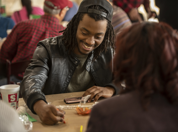 De'Jon Edwards enjoyed playing a game of Tic Tac Toe with crayons provided at each dining table during the Community Thanksgiving, held at the Georgetown Community Center in San Gabriel Park on Thursday, November 23, 2023.