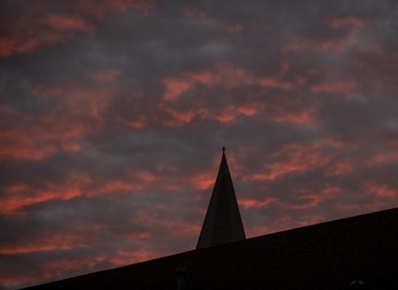 The skies transform over the spire of  Immanuel Lutheran Church for their Pilgrimage to Bethlehem, the church's Live Nativity, on Saturday, December 9, 2023.