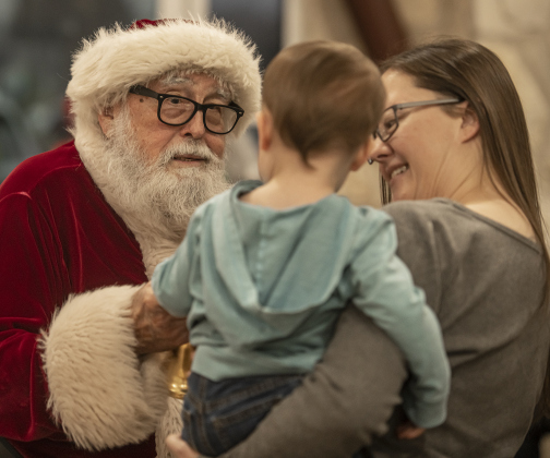 Santa Claus  visits with 16-month-old Rhett Love, with his mom Stephanie Love.