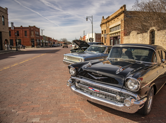 A 1957 Chevrolet 210 (front) owned by Terry Tschoerner, a 1963 Ford Fairlane owned by Joe Tschoerner (Terry's brother) and a 1996 GMC pickup, also owned by Joe Tschoerner, are lined up along  East Clark Street  on Saturday, January 20, 2024 during Pistons On The Bricks, a car show and photography event hosted by the Texas Photography Festival.