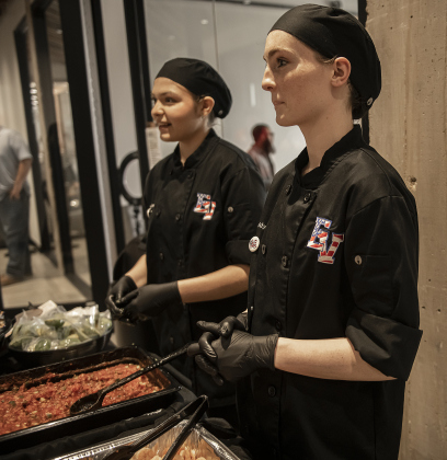 East View High Culinary Arts students Maddy Card, 17, front, a junior, and Nailah Gordon, 17, a senior, were serving up Campechana Mexican Shrimp Cocktails during the Georgetown Independent School District State of the District event held at GISD headquarters on Thursday, February 15, 2024.    Photo by Andy Sharp.  