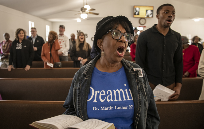 Paulette Taylor, front, joins others at Macedonia Baptist Church during the Dr. Martin Luther King, Jr. march and program held on Monday, February 19th, 2024. 