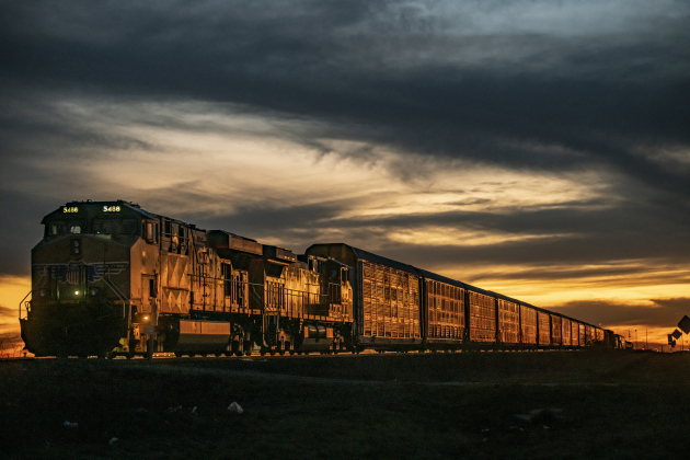 Warm evening light falls on the surface of freight train cars parallel to United States Highway 79 on Wednesday, January 31.  