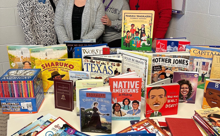 Members of the Robert Gilbert Livingston Chapter, National Society Daughters of the American Revolution, donated 145 English and Sp (anish elementary-level history books for their Community Classroom Project. COURTESY OF ROBERT GILBERT LIVINGSTON CHAPTER