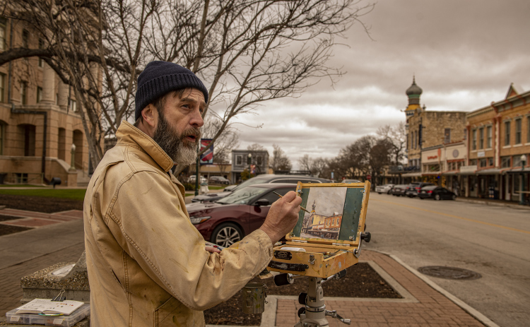 Paul Matula, a Plein Air painter from Austin, creates a painting at the corner of 8th and Main Streets on Saturday morning, January 27,2024.  He was joined by other Plein Air painters from Round Rock and Austin on a cloud-filled morning with temperatures near 50 degrees. Photo by Andy Sharp. 