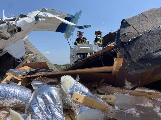  Firefighters explore the plane wreckage on the roof of the Northwood Drive home. Photo courtesy Georgetown Fire Department 
