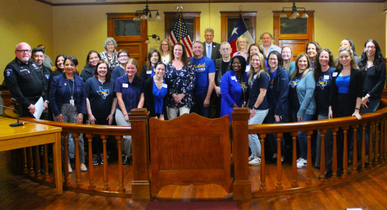 Representatives from the Williamson County Children’s Advocacy Center pose with the county commissioners during the April 9 meeting at the historic courthouse. Photo courtesy of Williamson County. 