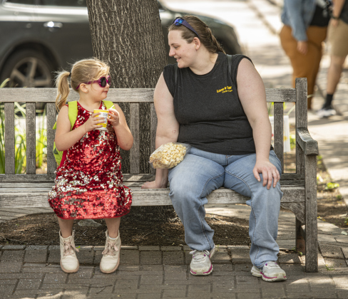 5-year-old Abigail Wilmot, enjoying a Kona Ice treat, dressed in a sparkly red dress to for her outing with mom Brittany Wilmot, right, as they relaxed 8th and Main Streets during Market Days, held Saturday, April 13. Photo by Andy Sharp