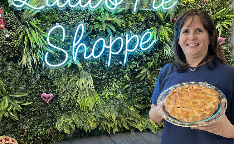 Lisa Franke stands with a cherry pie.