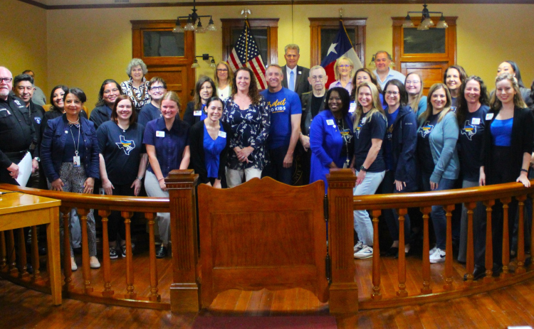 Representatives from the Williamson County Children’s Advocacy Center pose with the county commissioners during the April 9 meeting at the historic courthouse. Photo courtesy of Williamson County. 