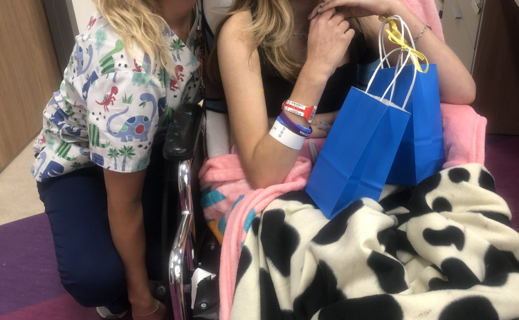 During her cancer treatment, Brooklynn Miller sits with a gift bag before giving it to a nurse at Dell Children’s Medical Center in Austin. 