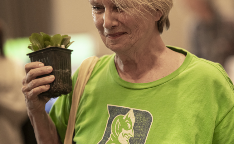Nancy Adair holds a Lyre Leaf Skullcap plant she received from the Sun City Plant Club during Sun City's Earth Day Celebration event held at The Retreat in Sun City on Monday, April 22. The event was hosted by Sun City Texas Recycles. The first Earth Day was on this date in 1970.  PhotoS by Andy Sharp