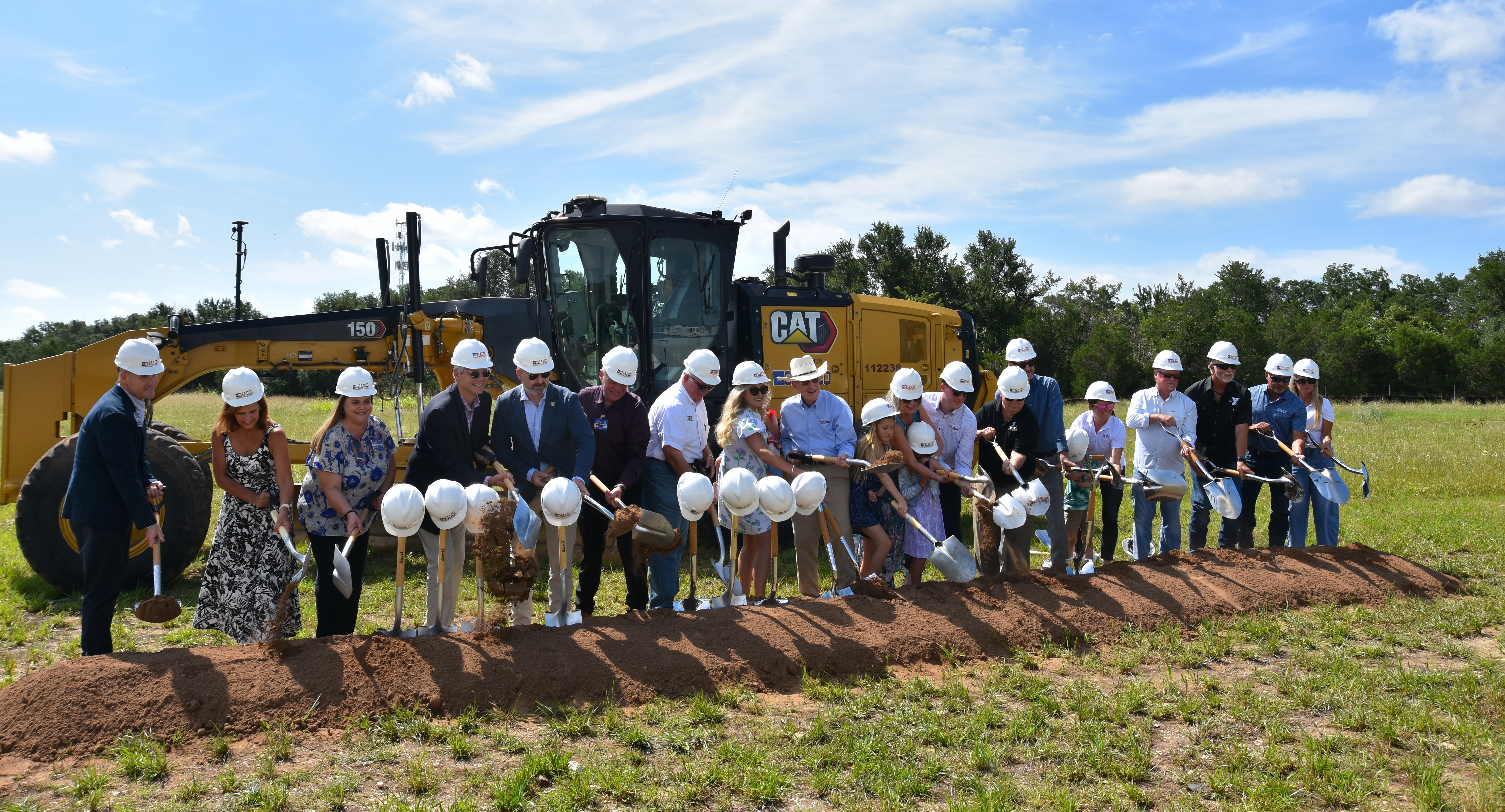 Representatives from the YMCA, Wellspring United Methodist Church, SportClips, the City of Georgetown, H-E-B, the WD Kelley Foundation and the Georgetown Health Foundation gather to turn dirt on the SportClips Family YMCA. (Photo by Kaitlyn Wilkes)