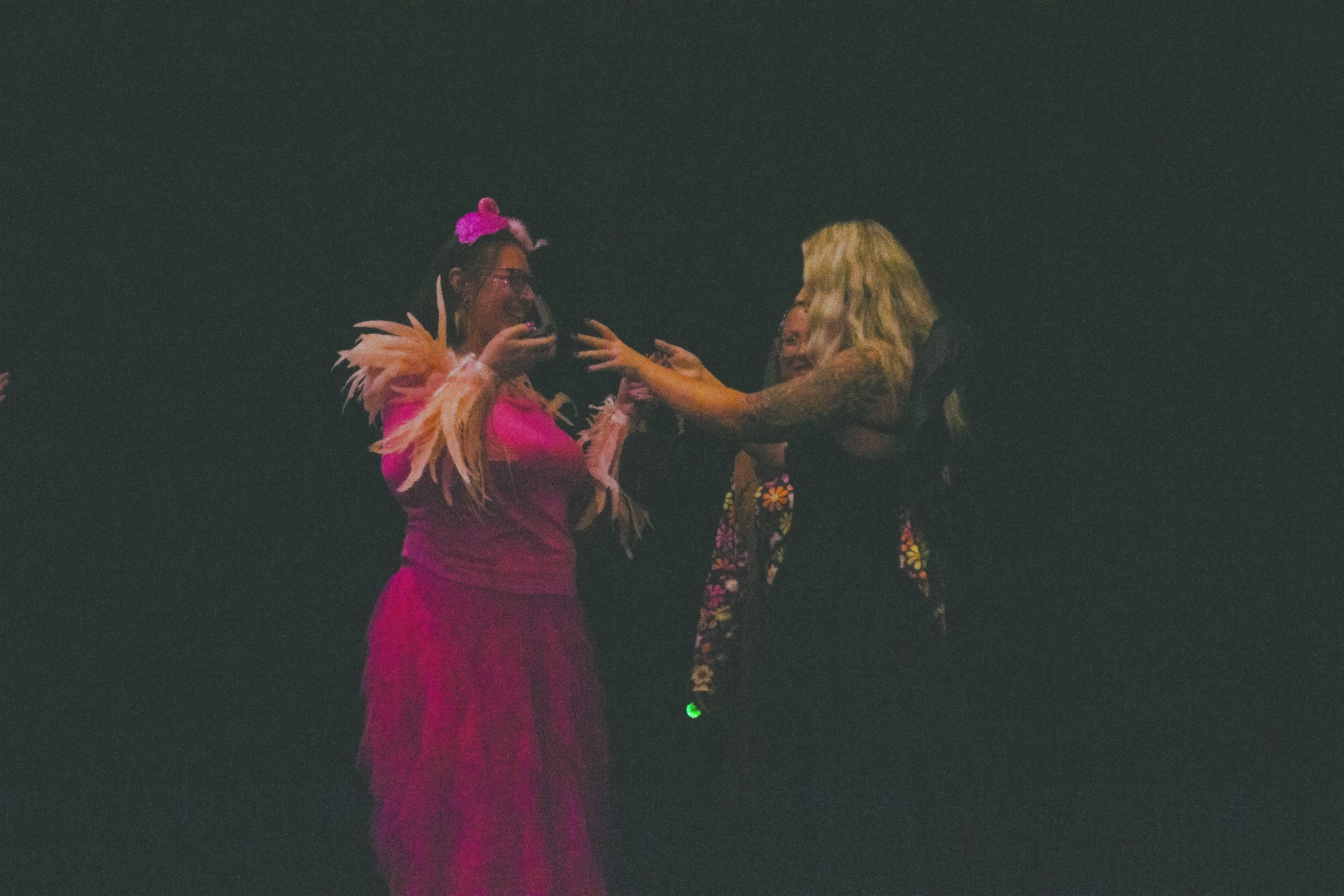 Amanda Morey, left, wins the blackout bingo prize: a YSL round black purse with a set of earrings from Diamonds Direct at the seventh annual Heroes, Hope and Handbags Purse Bingo on September 12. Photo by Nalani Nuylan.