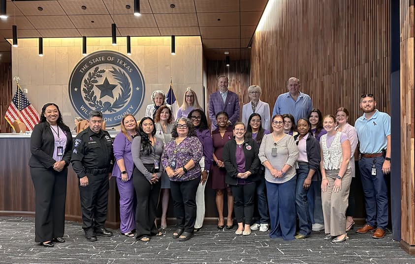 Staff from Yesterday’s Gone, Hope Alliance and law enforcement pose with the Williamson County Commissioners to spread awareness of domestic violence and abuse. Purple is the official awareness color. Photo courtesy of Williamson County
