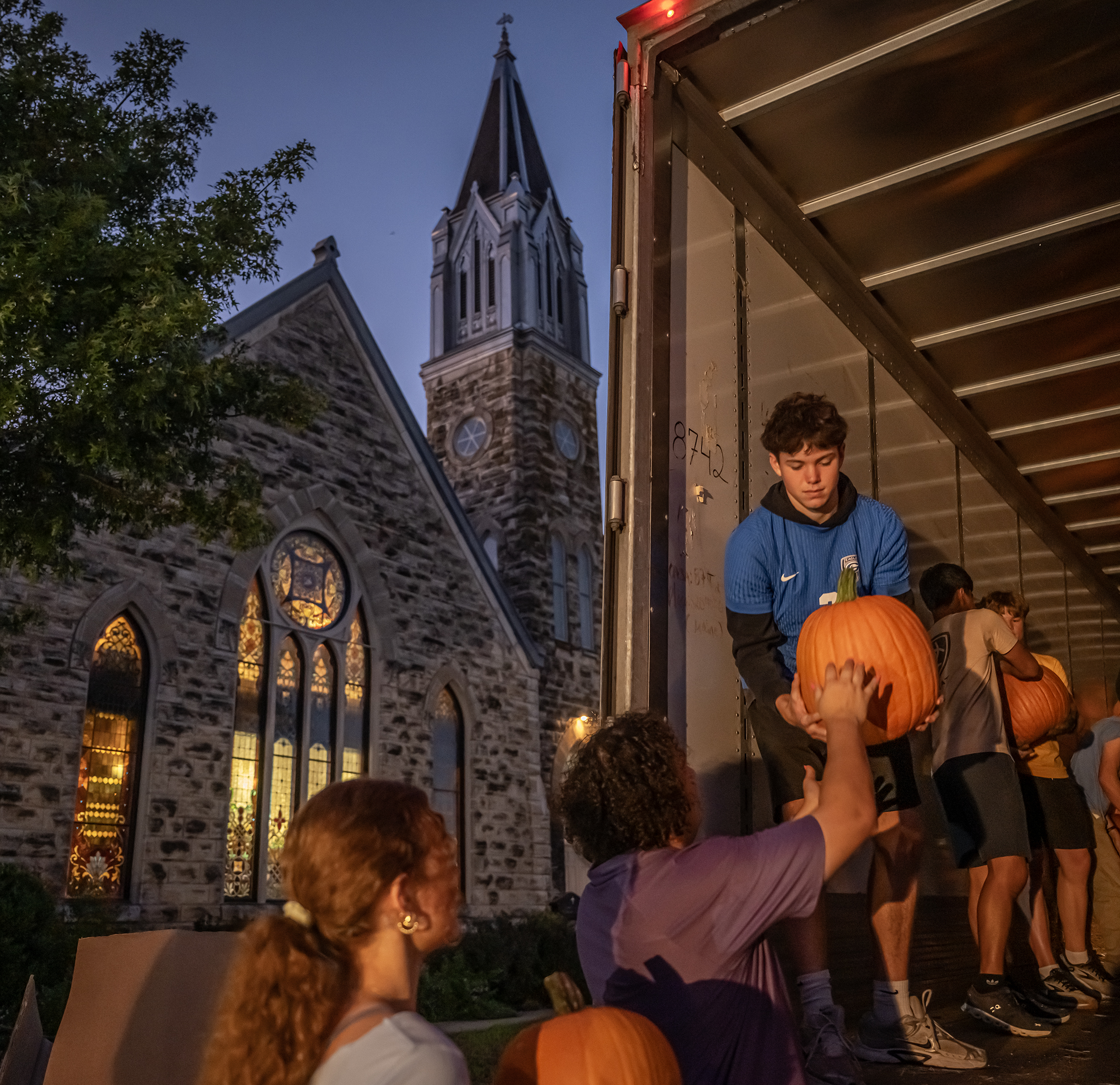 Chase Helm, a member of the Georgetown High School soccer team, helps unload 3,000 pumpkins at Georgetown’s First United Methodist Church on Wednesday, October 7. The truckload of pumpkins arrived at the church just before 7 p.m., a 13-hour drive from Farmington, New Mexico. Another 1,500 pumpkins will arrive on October 18. Pumpkins will be available through October 31. (Photos by Andy Sharp)