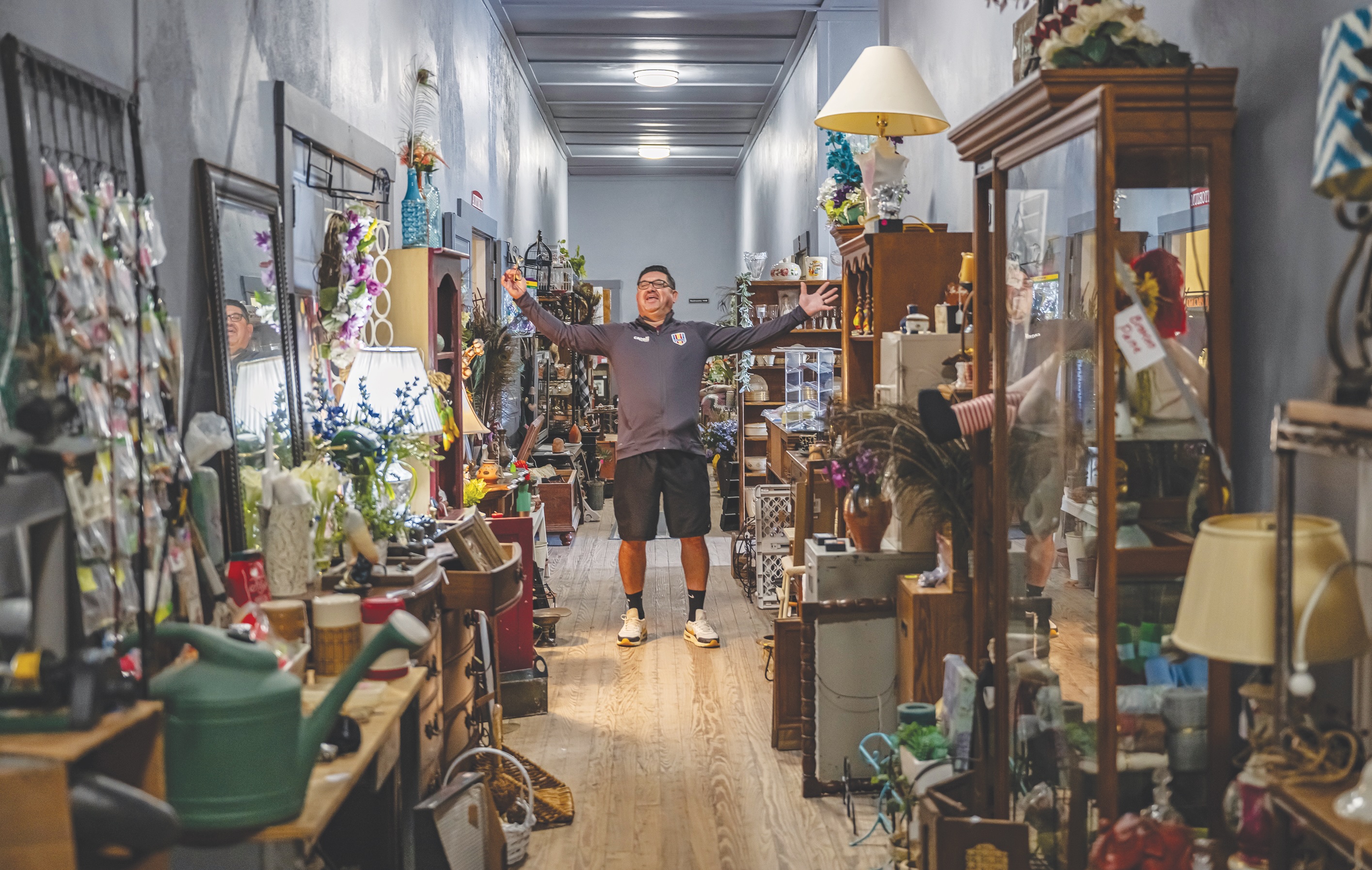 Randy Galvan enjoyed the ambience of a hallway loaded with items for sale  at the Jonah and Weir Community Sale, held at the Jonah Community Center (formerly Jonah School, built in 1922)  on Saturday, March 22, 2025.   17 vendors were on hand, with many items inside the historic structure.  Funds raised go toward continued restoration of the school.   Every Thursday at 6:30 p.m.  free movies are offered to the public.