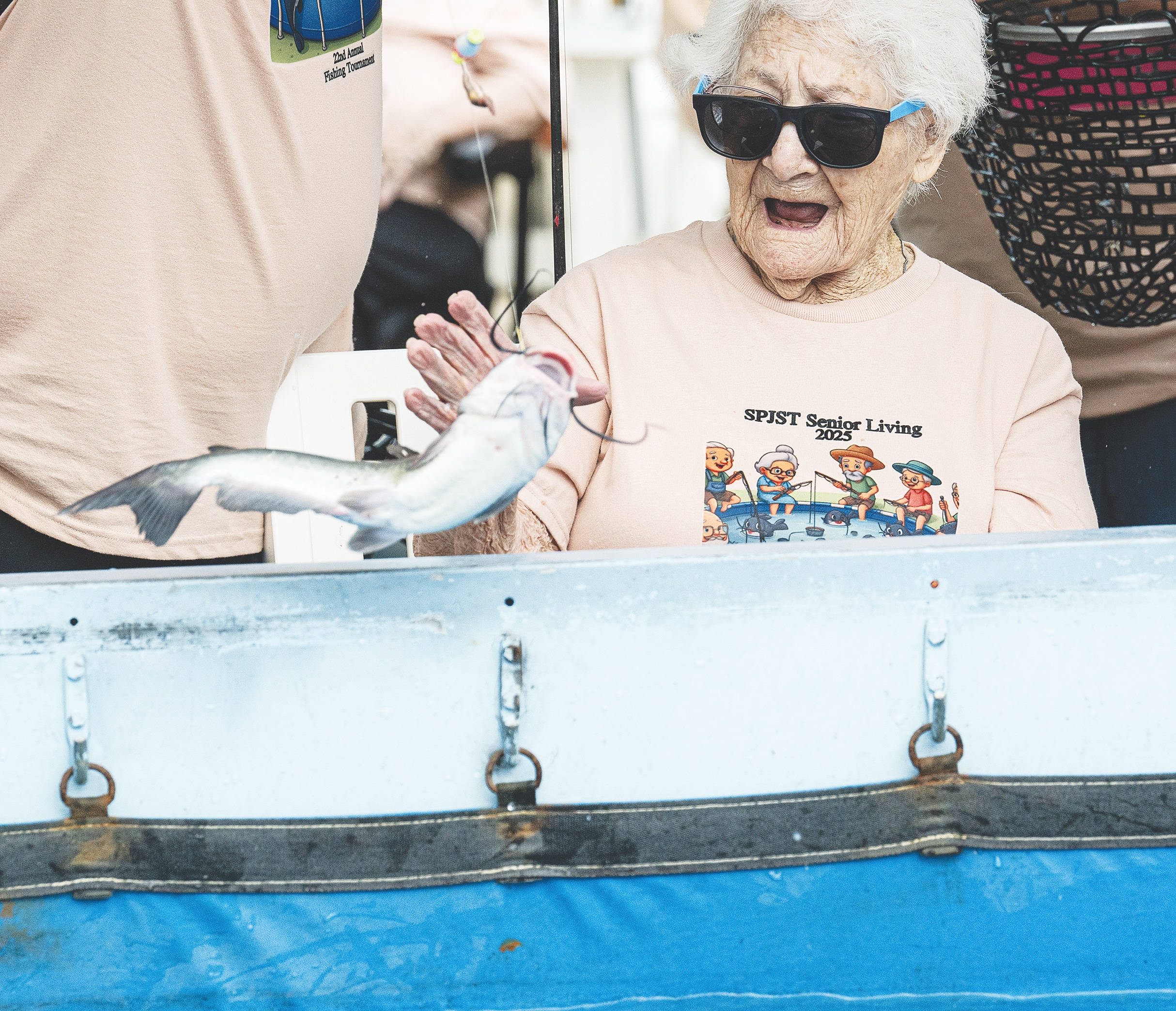 100-year-old Bertha Pistone reacts to a fish she caught during the 22nd Annual Fishing Tournament held at Taylor’s SPJST Senior Living  on Thursday, April 24.