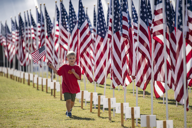 Cipriano Coffey, 5, runs past flags at the Field of Honor while carrying his own American flag Saturday, November 5. His father, William Coffey, is a Marine Corps veteran. The Field of Honor, sponsored by the Rotary Club of Georgetown, will be on display at San Gabriel Park throughout the week. See more on photos, schedule on Page 9 and in Salute to Veterans