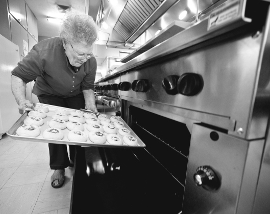 Church member Margaret Vrana, 82, places a batch of cherry kolaches in the oven in the recreation center kitchen during the annual Kolache Bake Sale at Saint Cyril &amp;amp; Methodius Catholic Church November 15, 2014. See this year’s event in the next Sunday Sun. SUN ARCHIVE