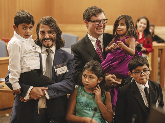 Jason Sierra, left, and his husband Josh Thomas, right, with the four children they adopted, including Tristan, 5 (with Jason), Tianna, 3 (with Josh), Jeslyn, 9, lower left, and Jesse, 10, lower right.