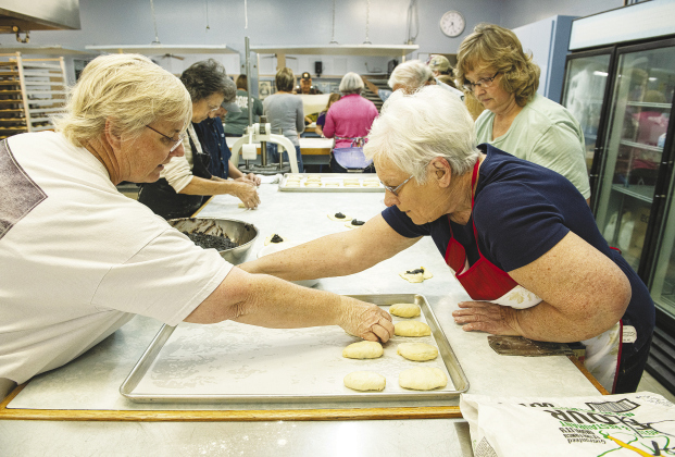 Kate Strmiska, left, and Shirley Volek, right, help prepare poppyseed kolaches during the annual Kolache Bake at Saints Cyril & Methodius Catholic Church November 19. Now in its 60th year, church members prepared 350 dozen kolaches, some of the helpers beginning as early as 4 a.m. that morning. Types of kolaches made included prune, apricot, cream cheese, pineapple and poppyseed. (Photos by Andy Sharp)