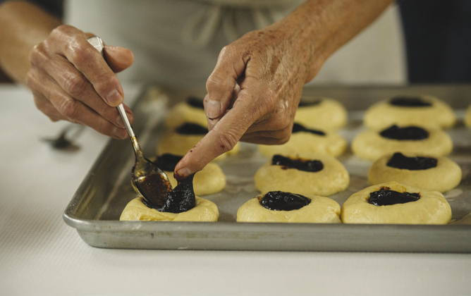 Above, Pat Greger adds prune filling. Types of kolaches made for the sale November 19 included prune, apricot, cream cheese, pineapple and poppyseed.