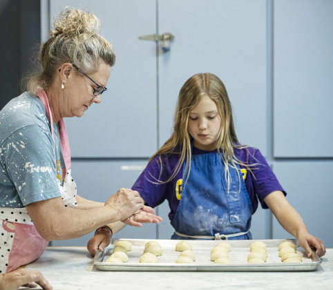 Above, Anne Shirocky adds pineapple filling to kolache dough before baking November 19. Left, Lillie Huf, works with her granddaughter Audrie Huf, 11, as they prepare kolache dough for fillings during the annual Kolache Bake at Saints Cyril &amp;amp; Methodius Catholic Church Saturday, November 19. Now in its 60th year, church members prepared 350 dozen kolaches, some of the helpers beginning as early as 4 a.m.