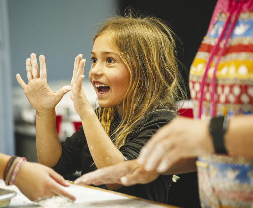 Kailyn Huf, 6, smiles when showing her dough-covered hands to her grandmother, Lillie Huf. Photos by ANDY SHARP